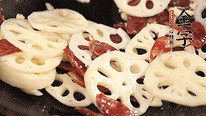 依次下香腸片、藕片翻炒均勻，加適量清水燜熟。