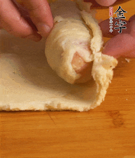 吐司卷起香腸，吐司尾端涂抹少許全蛋液，卷好的吐司表面蘸上蛋液，在裹上一層面包糠，送入預(yù)熱好的烤箱中。