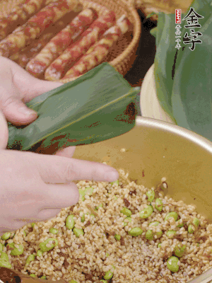 粽葉往下折，完全蓋住，兩側(cè)捏緊。