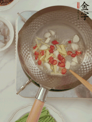 油7成熱時，下大蒜粒、姜絲、小米辣煸香。